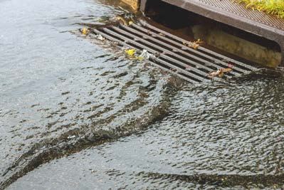 storm drain with water flowing down