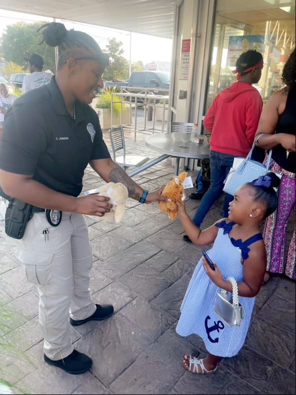 Photo of Officer Johnson interacting with child at Coffee with a Cop event